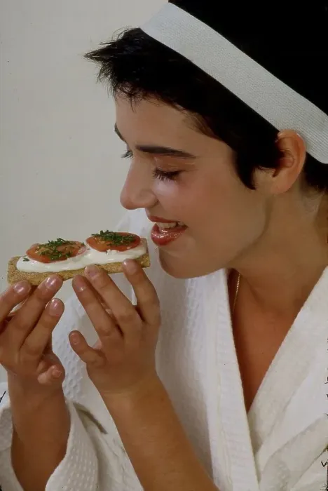 Framed Print : Young woman eats crispbread with curd cheese and tomato Framed Print : Young woman eats crispbread with curd cheese and tomato