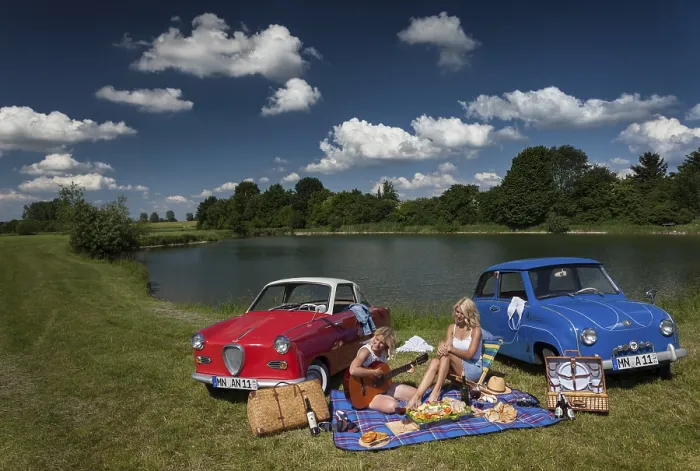 Framed Print : Two young woman having a picnic next to two vintage cars at the lake in sunny weather Framed Print : Two young woman having a picnic next to two vintage cars at the lake in sunny weather