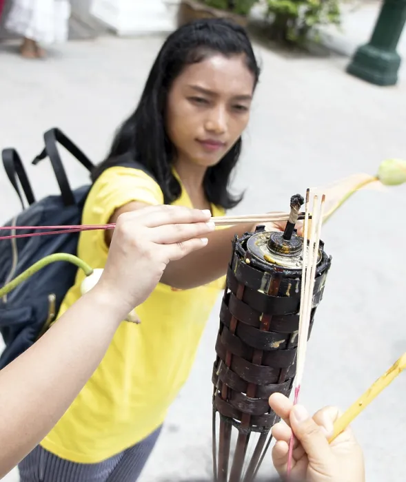 Framed Print : A young woman ignite stick in the Buddhist temple at Buddhist holiday Visakha (Vesak) Bucha day