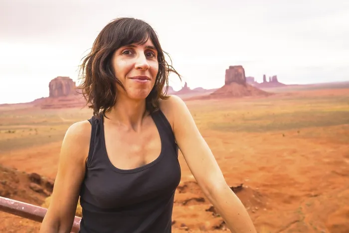Framed Print : A young woman looking in a cloudy Monument Valley National Park