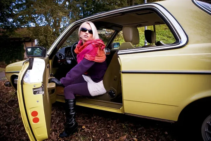 Framed Print : Young woman in a post-war classic car