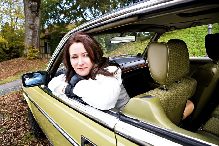 Framed Print : Young woman in a post-war classic car