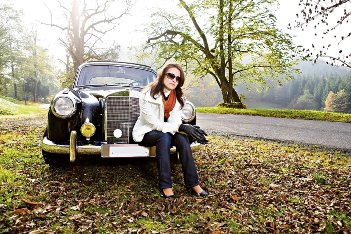 Framed Print : Young woman in front of a post-war classic car Framed Print : Young woman in front of a post-war classic car