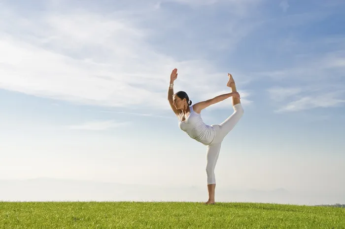 Framed Print : Young woman practising Hatha yoga outdoors