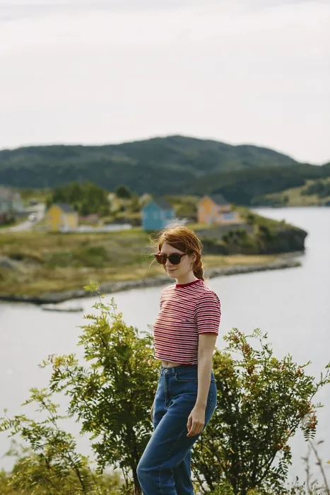 Framed Print : A young woman with red hair, wearing sunglasses