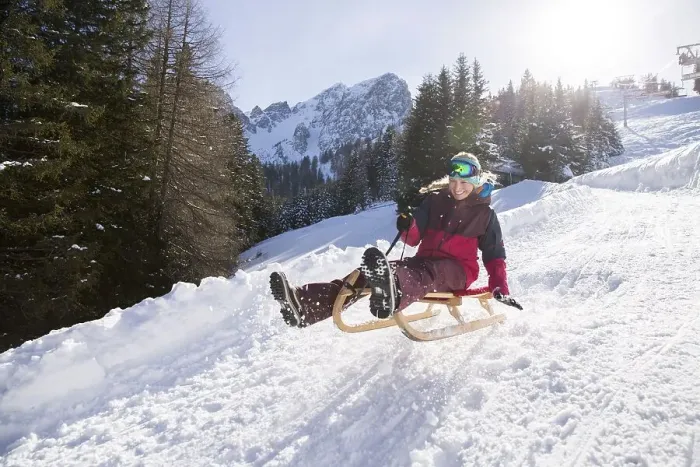 Framed Print : Young woman riding on a sledge