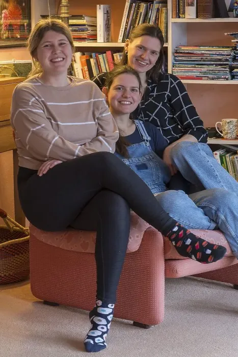 Framed Print : Three young woman sitting on an armchair