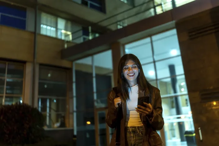 Framed Print : Young woman standing on a city street at night Framed Print : Young woman standing on a city street at night