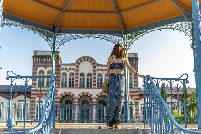 Framed Print : Young woman standing under a colorful gazebo