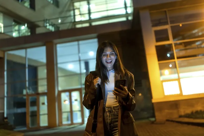 Framed Print : Young woman standing on an urban street at night Framed Print : Young woman standing on an urban street at night