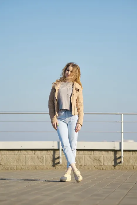 Framed Print : A young woman stands on a modern rooftop terrace