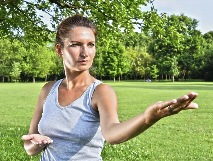 Framed Print : Young woman during tai chi exercise in the park