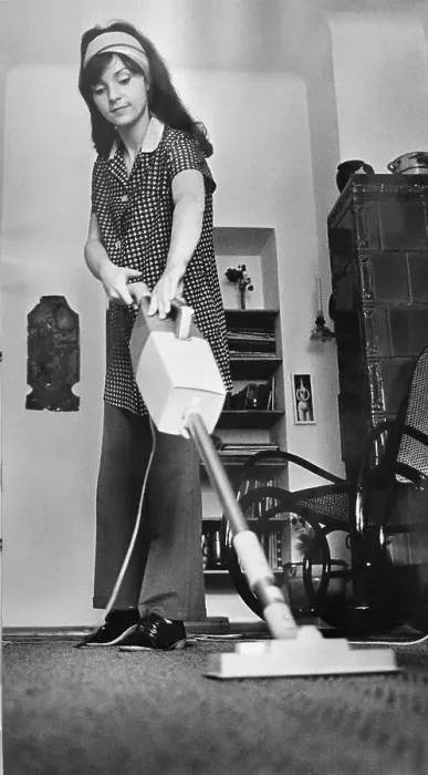 Framed Print : Young woman vacuuming, East Germany Framed Print : Young woman vacuuming, East Germany