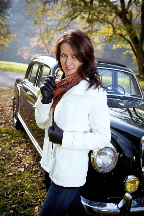 Framed Print : Young woman in front of a vintage car in a park in autumn Framed Print : Young woman in front of a vintage car in a park in autumn