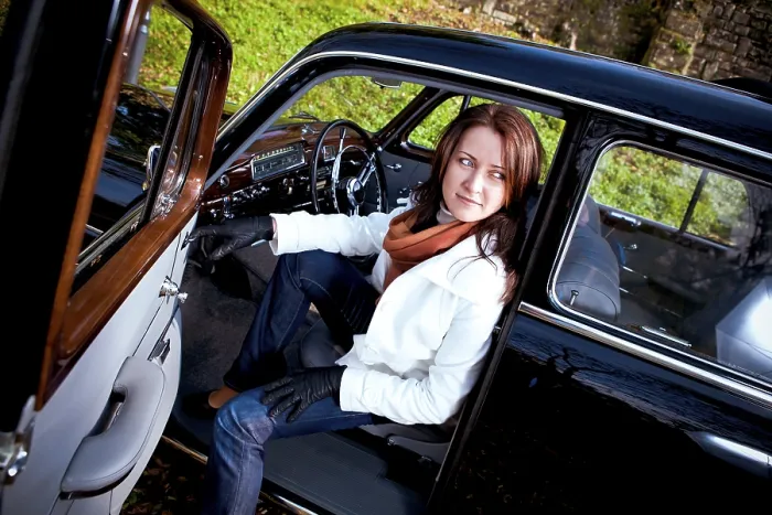 Framed Print : Young woman in a vintage MB vehicle