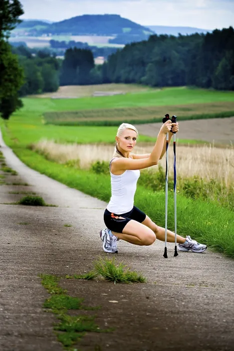 Framed Print : Young woman warming up for Nordic Walking
