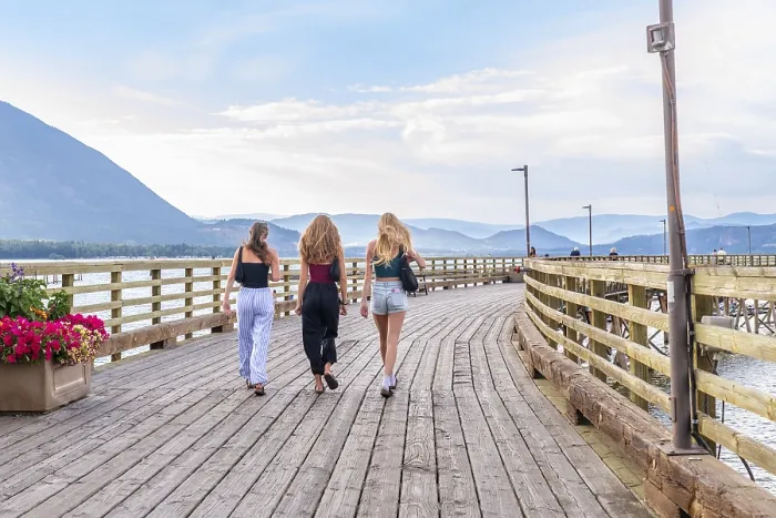 Framed Print : Three young women are enjoying a leisurely stroll along a scenic wooden pier in salmon arm Framed Print : Three young women are enjoying a leisurely stroll along a scenic wooden pier in salmon arm