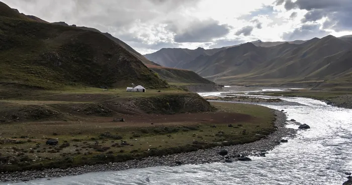Framed Print : Yurt by a river, Desolate mountain landscape