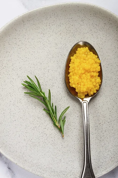 Framed Print : Yuzu caviar is pearly, on a spoon Framed Print : Yuzu caviar is pearly, on a spoon