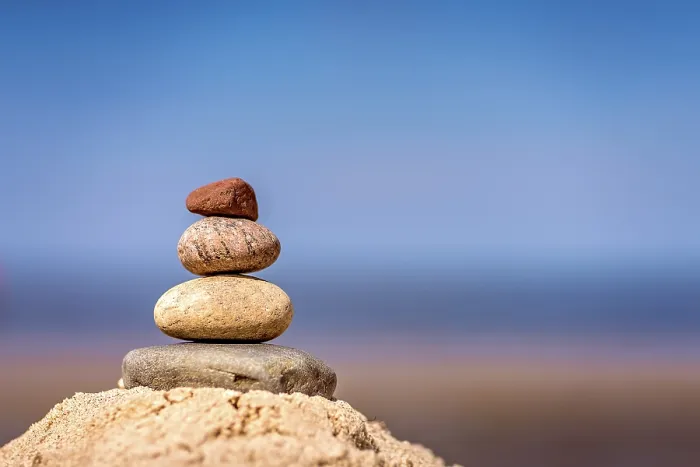 Framed Print : Zen balanced small pile of stacked stones on the beach in summer Framed Print : Zen balanced small pile of stacked stones on the beach in summer