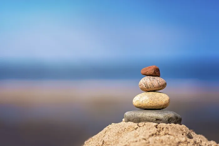 Framed Print : Zen balanced small pile of stacked stones on the beach in summer Framed Print : Zen balanced small pile of stacked stones on the beach in summer