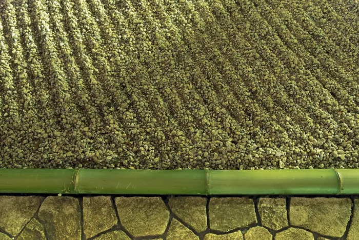 Framed Print : Zen stone garden fragment under vivid night illumination with sand waves and bamboo pole border