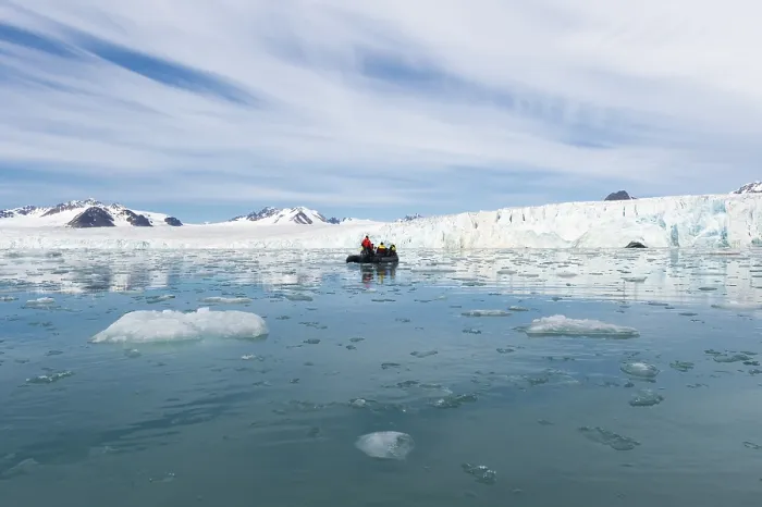 Framed Print : Zodiac boat with tourists navigating in front of Lilliehook glacier