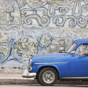 1950 Chevrolet parked in front of a mural