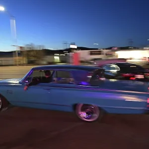 A 1964 Mercury Monterey turns onto Route 66 in the evening light
