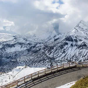 Abrupt turn on the wet road. The snow on the mountainside began to melt