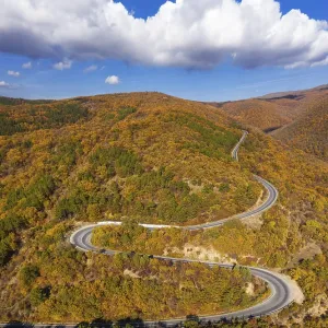 Aerial drone view of road in the mountain at autumn over sea resort Sunny Beach