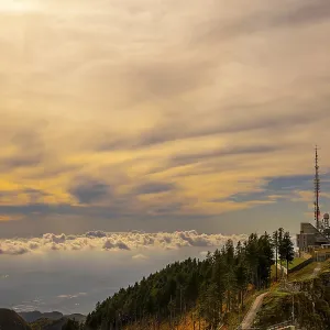 Aerial View over a Beautiful Meteorological and Communication Station with Trees on Mountain Peak