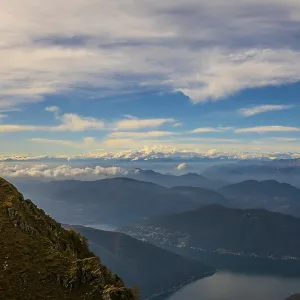 Aerial View over Beautiful Mountainscape with Snow Capped Mountain and Cloudscape Aerial View over Beautiful Mountainscape with Snow Capped Mountain and Cloudscape