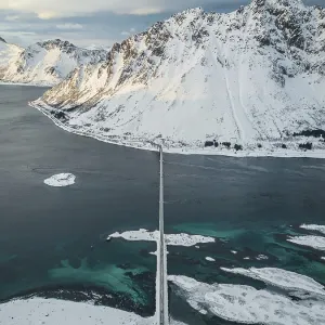 Aerial view, fjord landscape in winter with Gimsoystraumen bridge Aerial view, fjord landscape in winter with Gimsoystraumen bridge