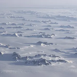 Aerial view, inland ice, ice sheet with glaciated mountain ranges Aerial view, inland ice, ice sheet with glaciated mountain ranges