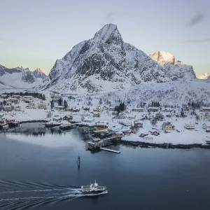 Aerial view of Reine with snow-covered mountains in winter Aerial view of Reine with snow-covered mountains in winter