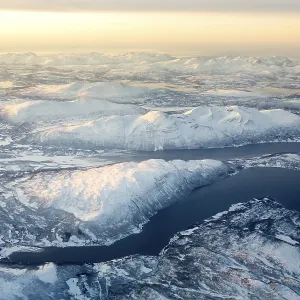 Aerial view, snow-covered mountains with fjord Aerial view, snow-covered mountains with fjord
