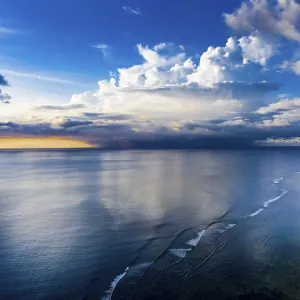 Aerial view, sunset, rain cloud over the sea on the horizon