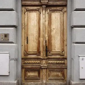 An aged wooden door with a rustic texture and historic architectural design An aged wooden door with a rustic texture and historic architectural design