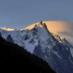 Aiguille du Midi with sun-lit cloud above the summit Aiguille du Midi with sun-lit cloud above the summit