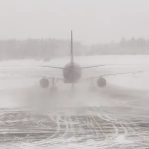 Airplane in bad weather, snow storm on snowy runway Airplane in bad weather, snow storm on snowy runway