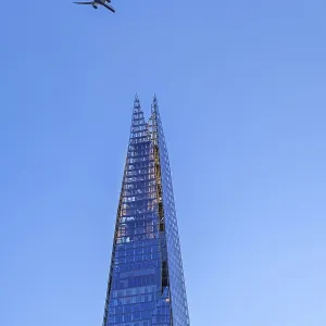 Airplane of British Airways flying over The Shard