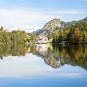 Alpsee lake with the royal castles of Schloss Neuschwanstein and Schloss Hohenschwangau in autumn