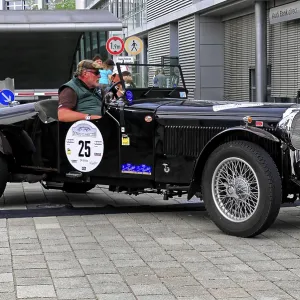 Alvis Crested EAGLE, black classic car with convertible roof at a rally event on cobblestones