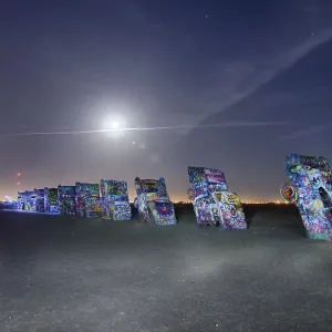 AMARILLO, TEXAS - April 2015: Famous art installation Cadillac Ranch at night AMARILLO, TEXAS - April 2015: Famous art installation Cadillac Ranch at night