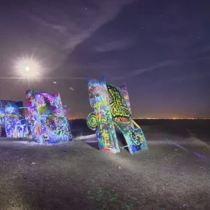 AMARILLO, TEXAS - April 2015: Famous art installation Cadillac Ranch at night AMARILLO, TEXAS - April 2015: Famous art installation Cadillac Ranch at night