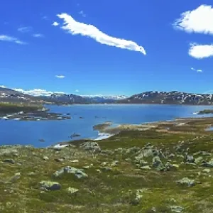 Amazing Vavatn lake panorama rough landscape view rocks boulders and mountains during summer in Hemsedal Norway Amazing Vavatn lake panorama rough landscape view rocks boulders and mountains during summer in Hemsedal Norway