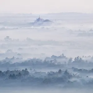 Amazing watercolor view of foggy morning landscape with farm fields and Gabar Lone Pagoda in mist at Thanlwin river Amazing watercolor view of foggy morning landscape with farm fields and Gabar Lone Pagoda in mist at Thanlwin river