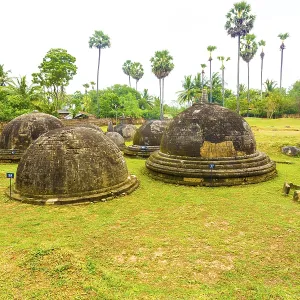Ancient Buddhist Kandarodai dagobas or stupas stand in middle of a field in Chunnakam