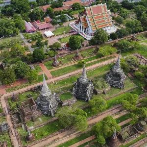 An ancient temple complex next to a city and a modern temple An ancient temple complex next to a city and a modern temple